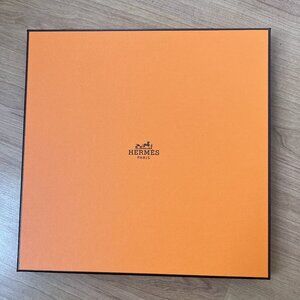 Hermès scarf box with ribbon and wrapping paper.